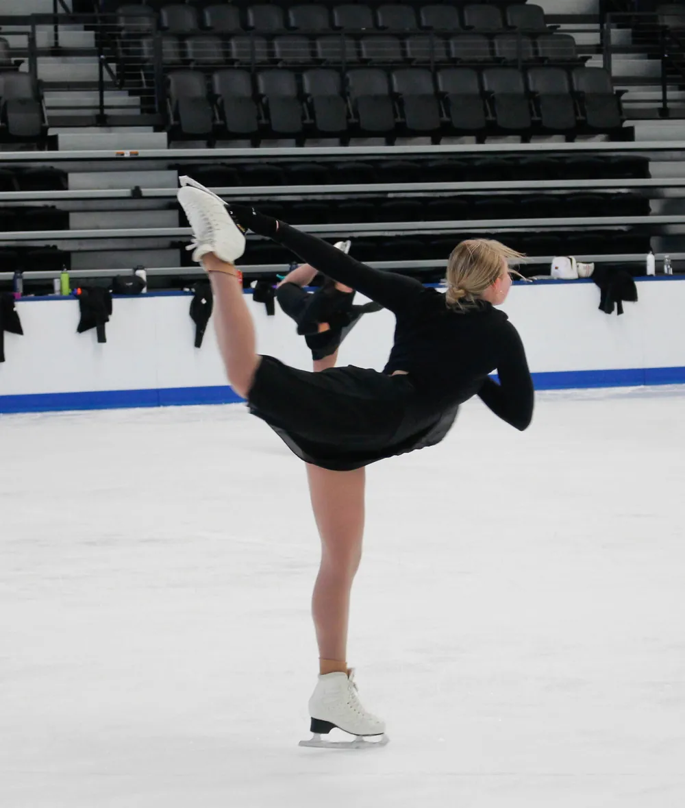 Synchronized skater holding a solo pose